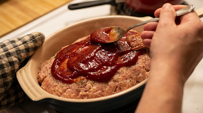 Turkey Meatloaf Glaze Step β Flavor Flip "Spreading tomato glaze on healthy turkey meatloaf before baking"