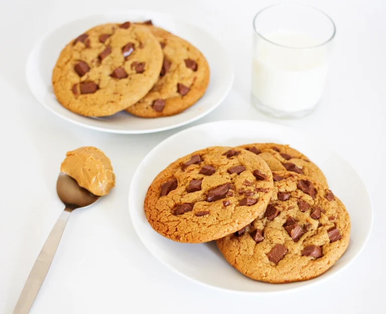 Chocolate chip cookies on plates with a glass of milk