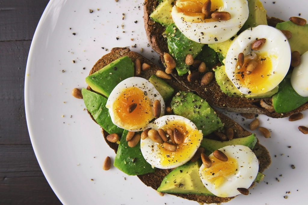 Avocado toast topped with soft-boiled eggs