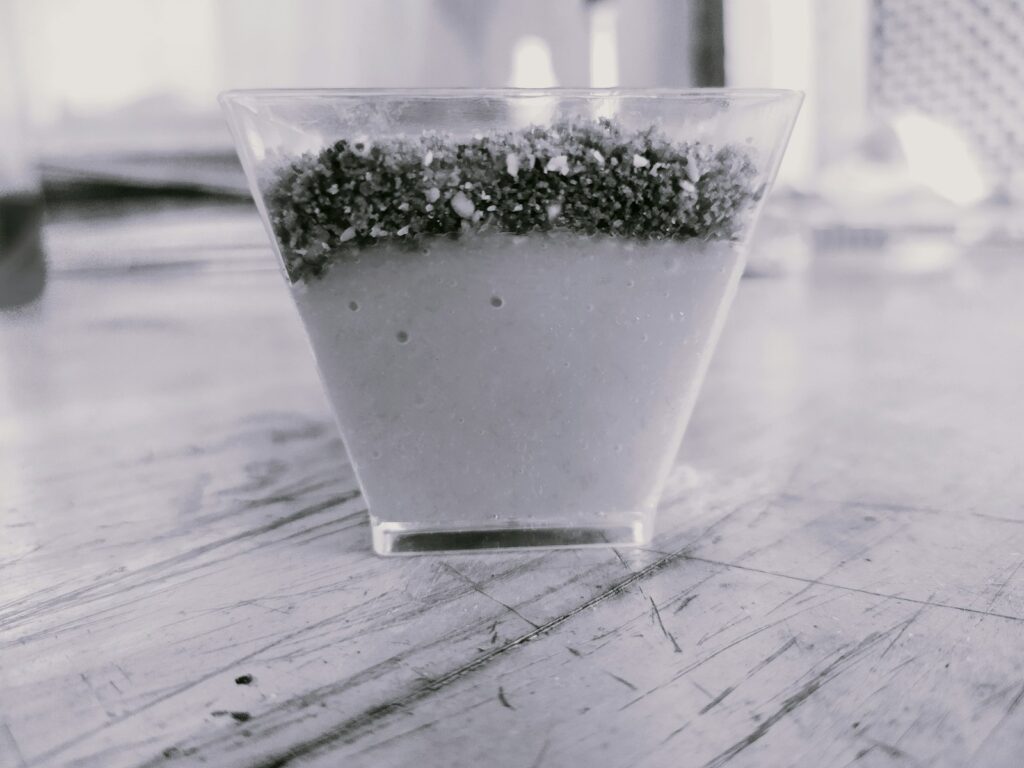 Chia seeds sitting on top of water in a glass before stirring