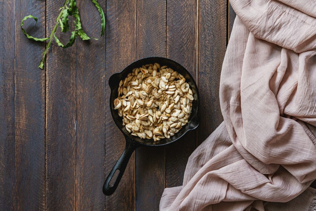 Roasted pumpkin seeds in a cast iron skillet