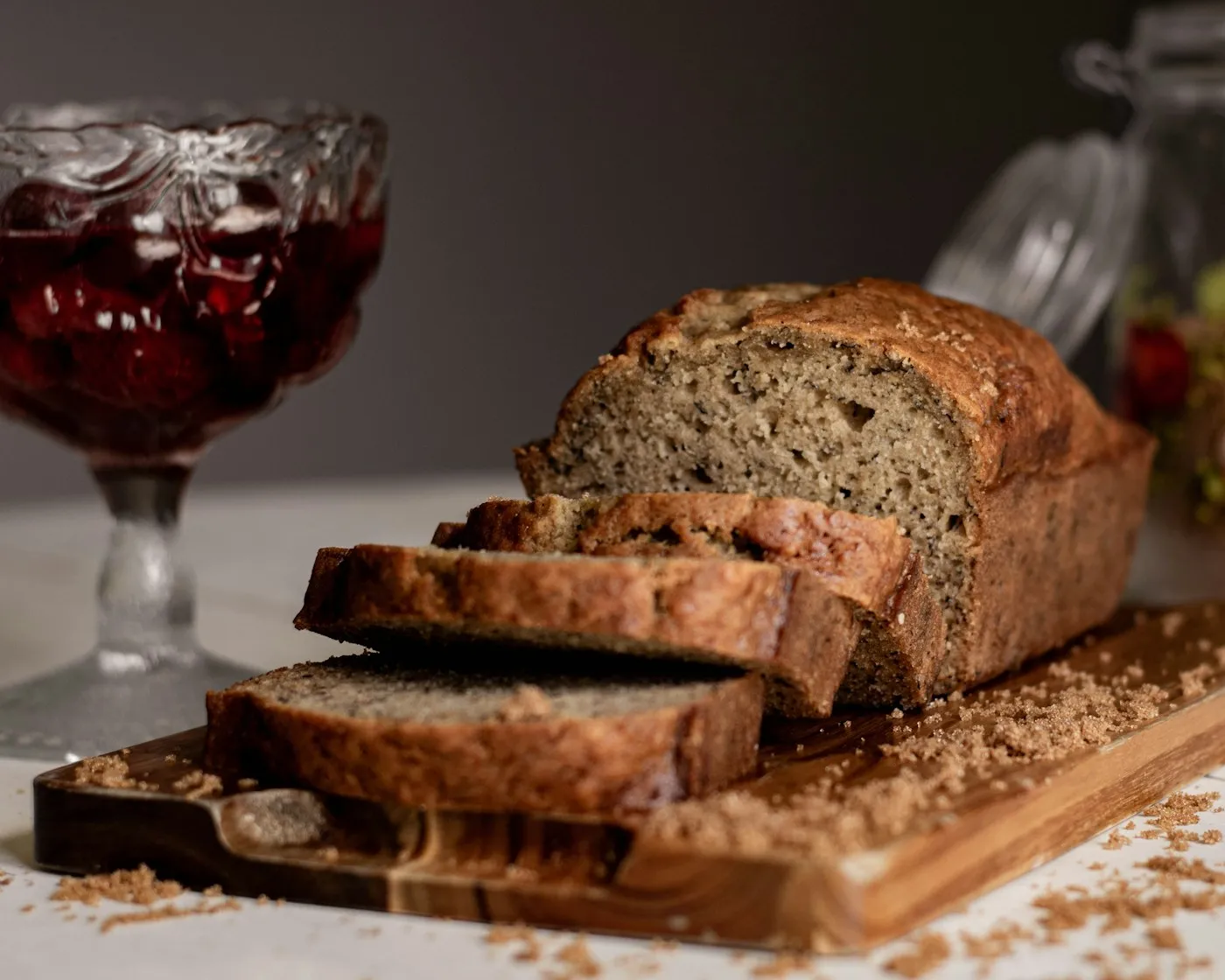 Sliced banana bread loaf on a wooden cutting board
